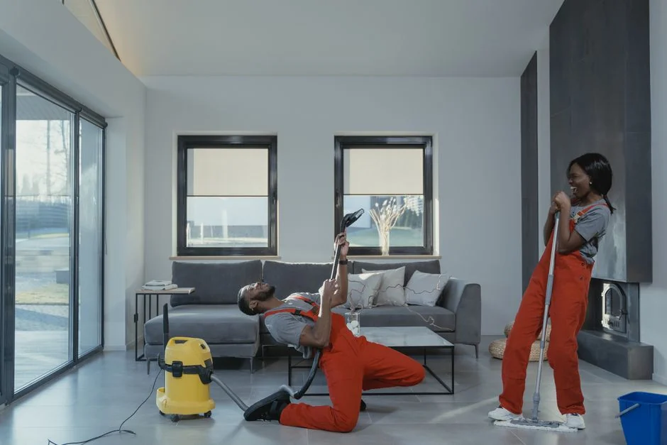 Window washers equipped with safety gear cleaning the facade of a high-rise building.